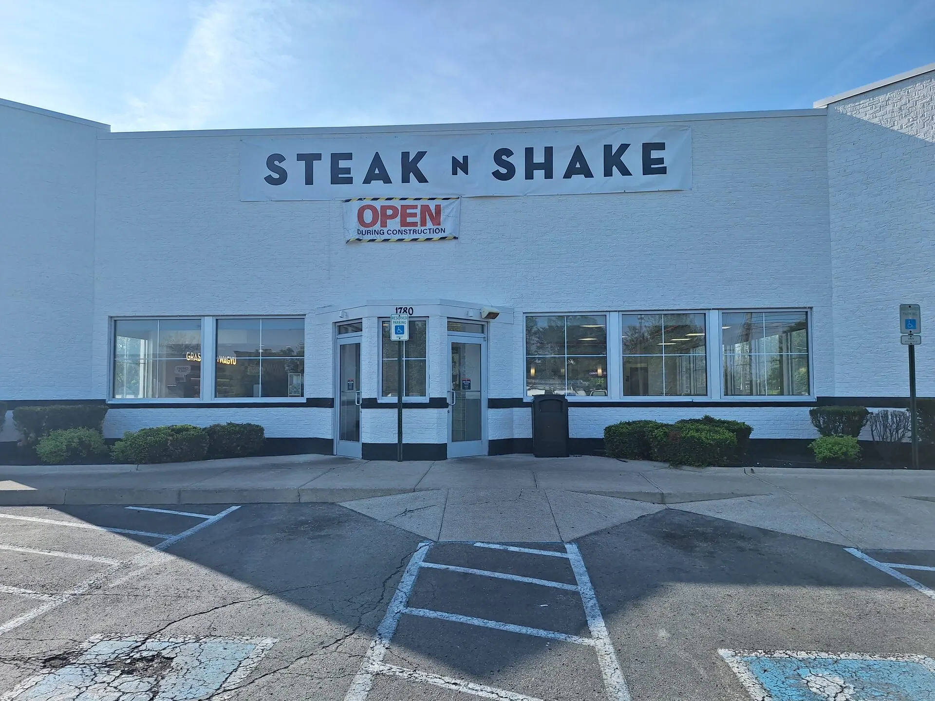 Steak 'n Shake commercial exterior repaint — front entrance with new white finish and black accent stripe