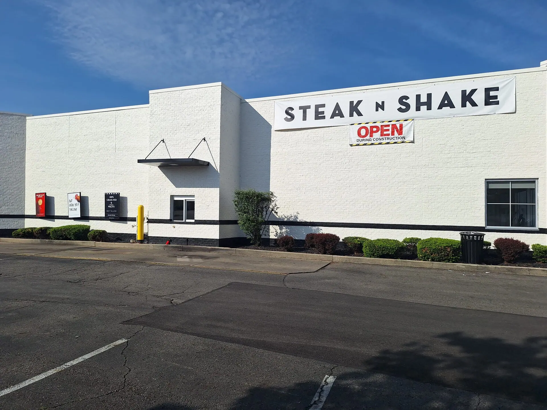 Steak 'n Shake commercial exterior repaint — side elevation with crisp white walls and black trim band