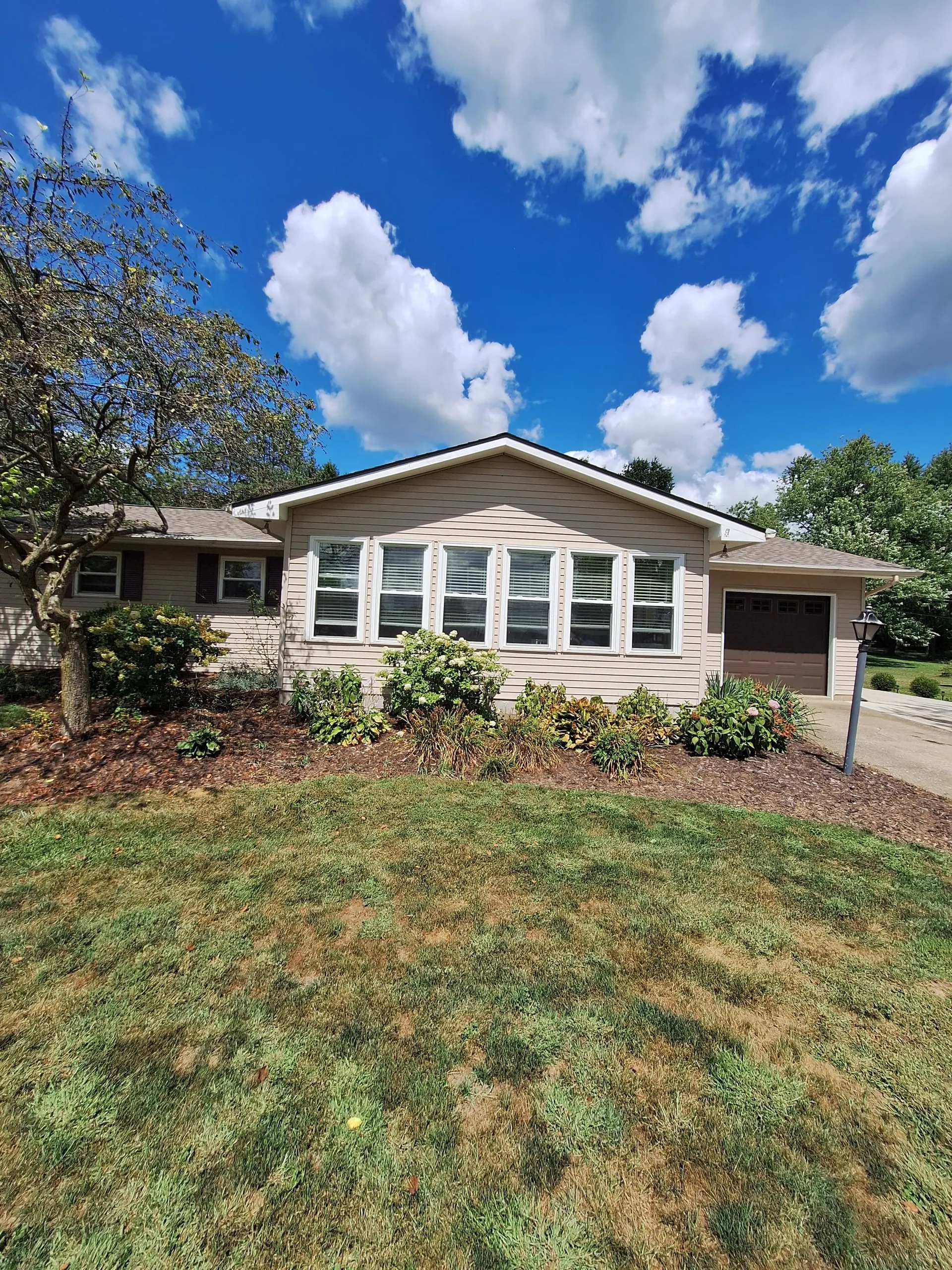 Home exterior painting with garage and trim