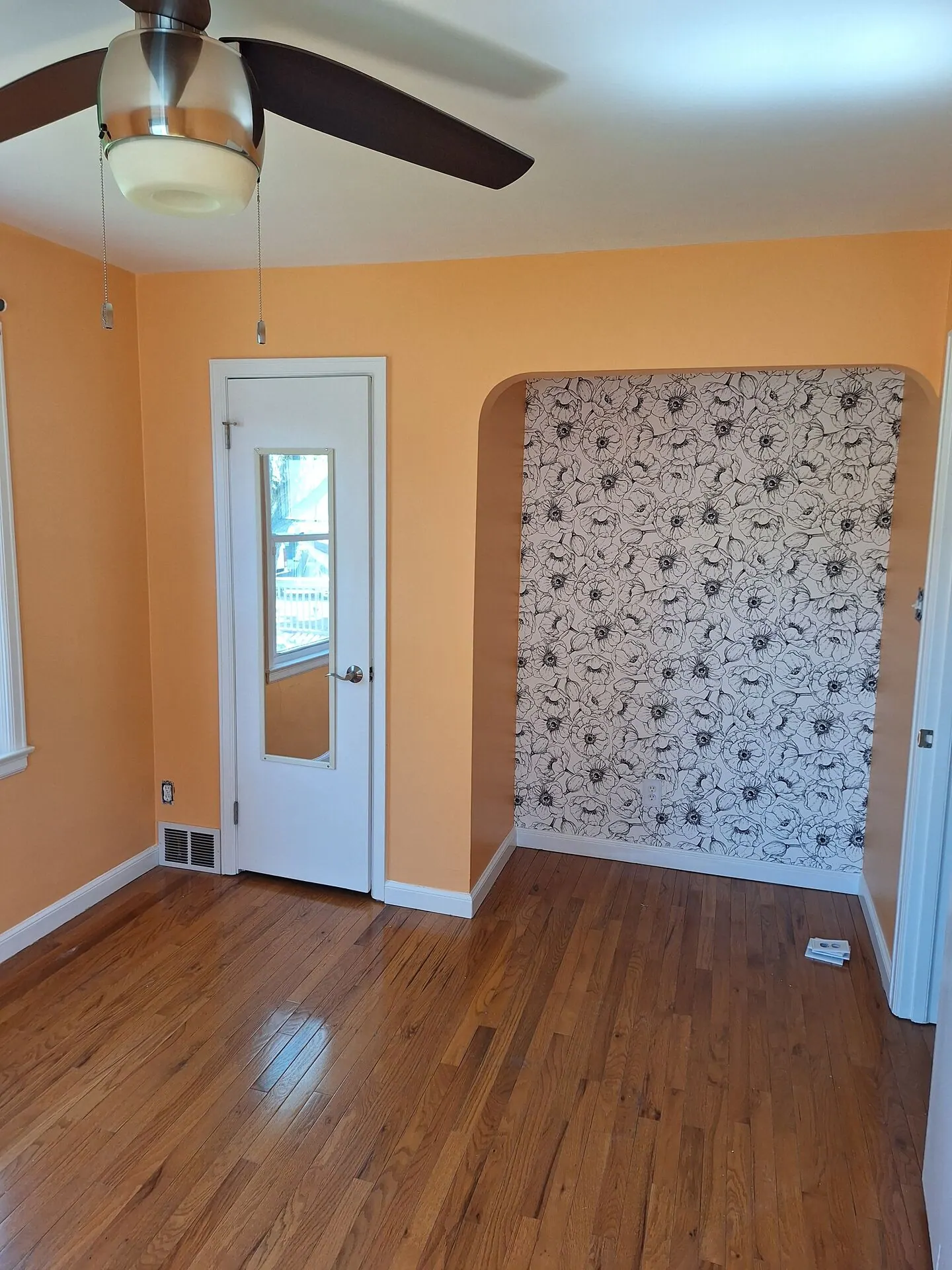 Apricot walls with a floral wallpapered accent alcove