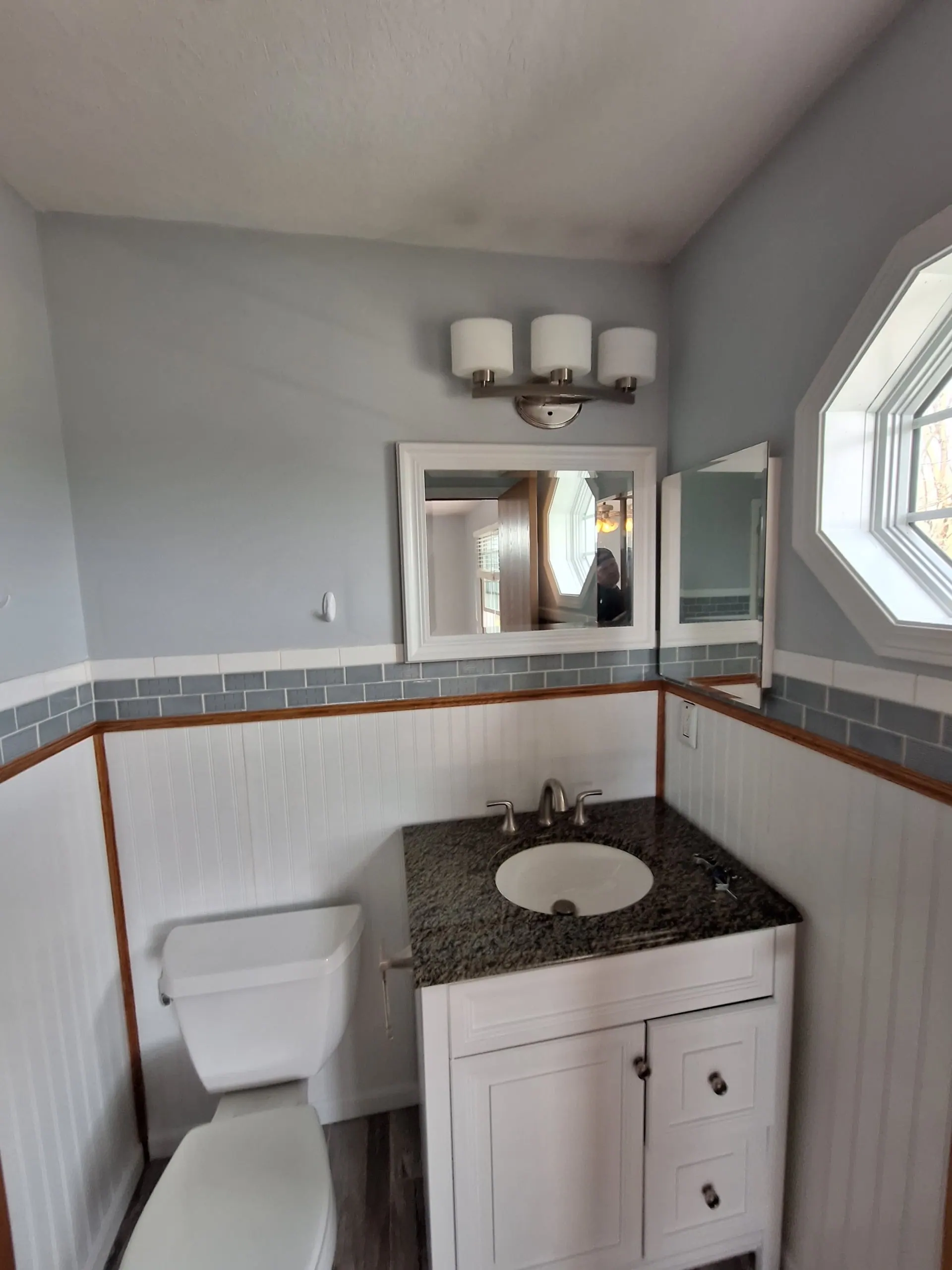 Freshly painted bathroom with clean blue-gray walls