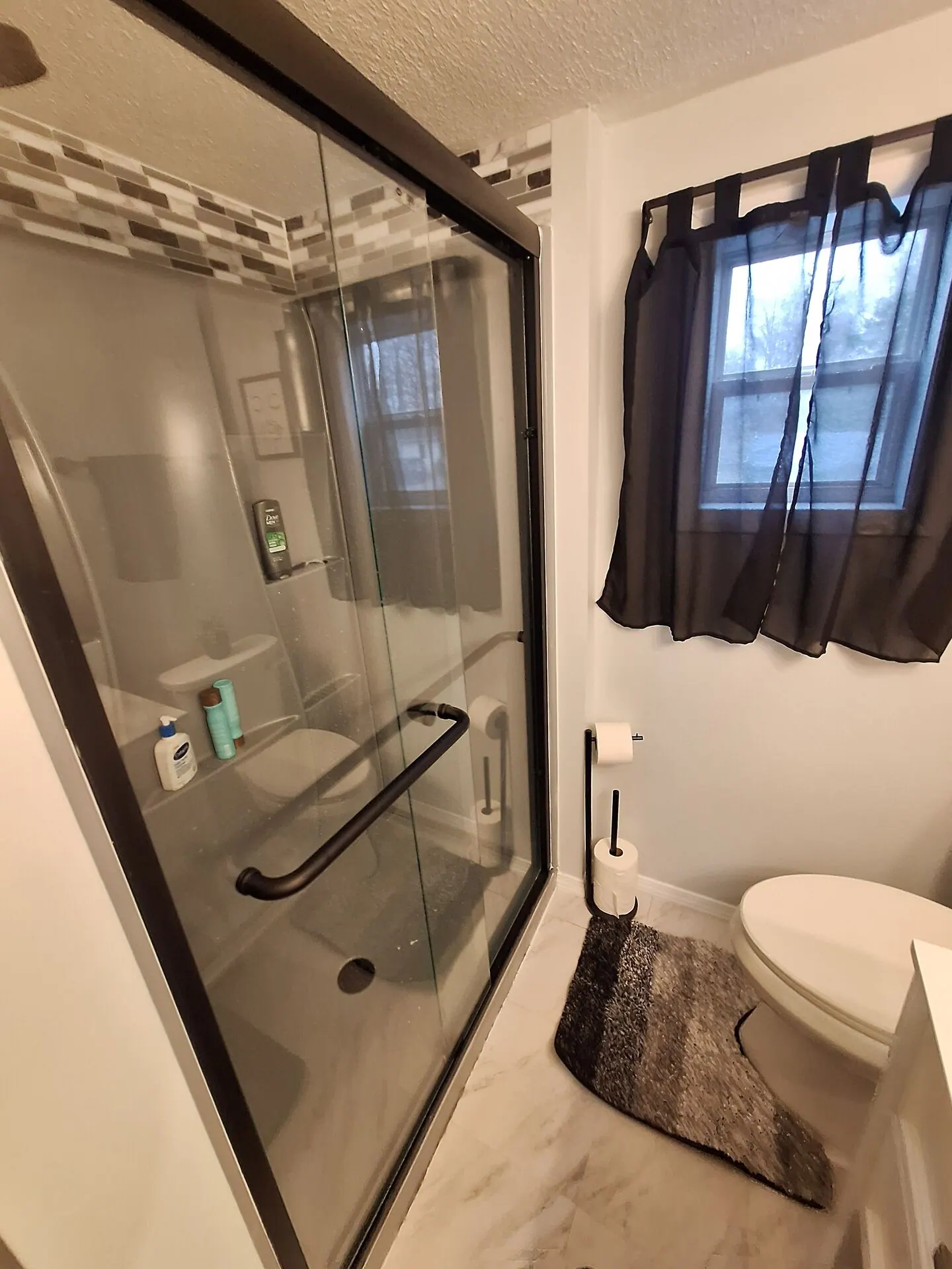 Freshly painted bathroom with glass shower enclosure