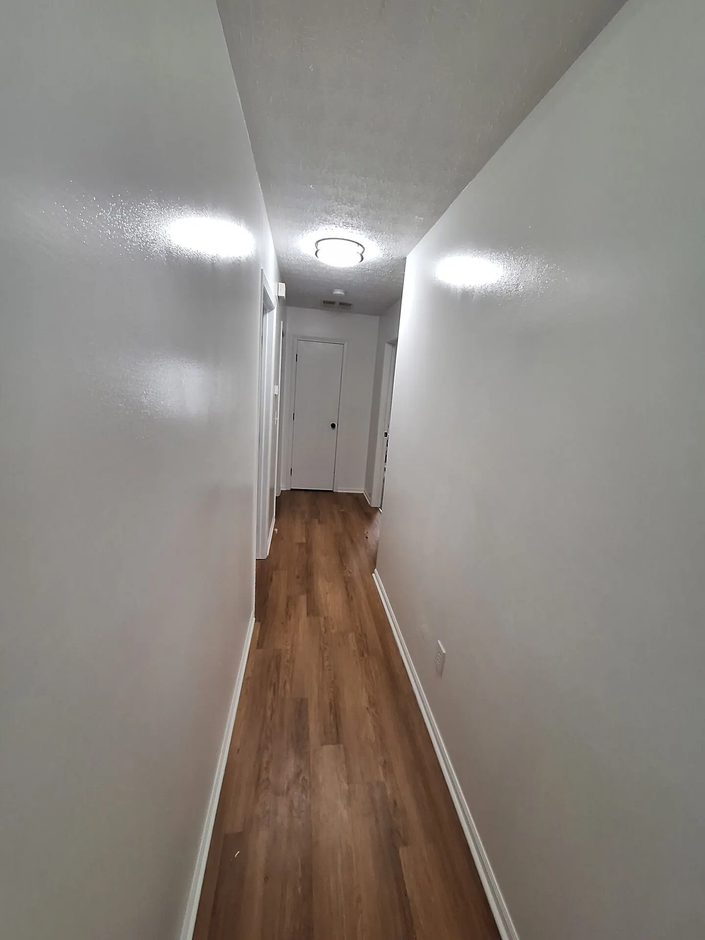 Long hallway painted bright white