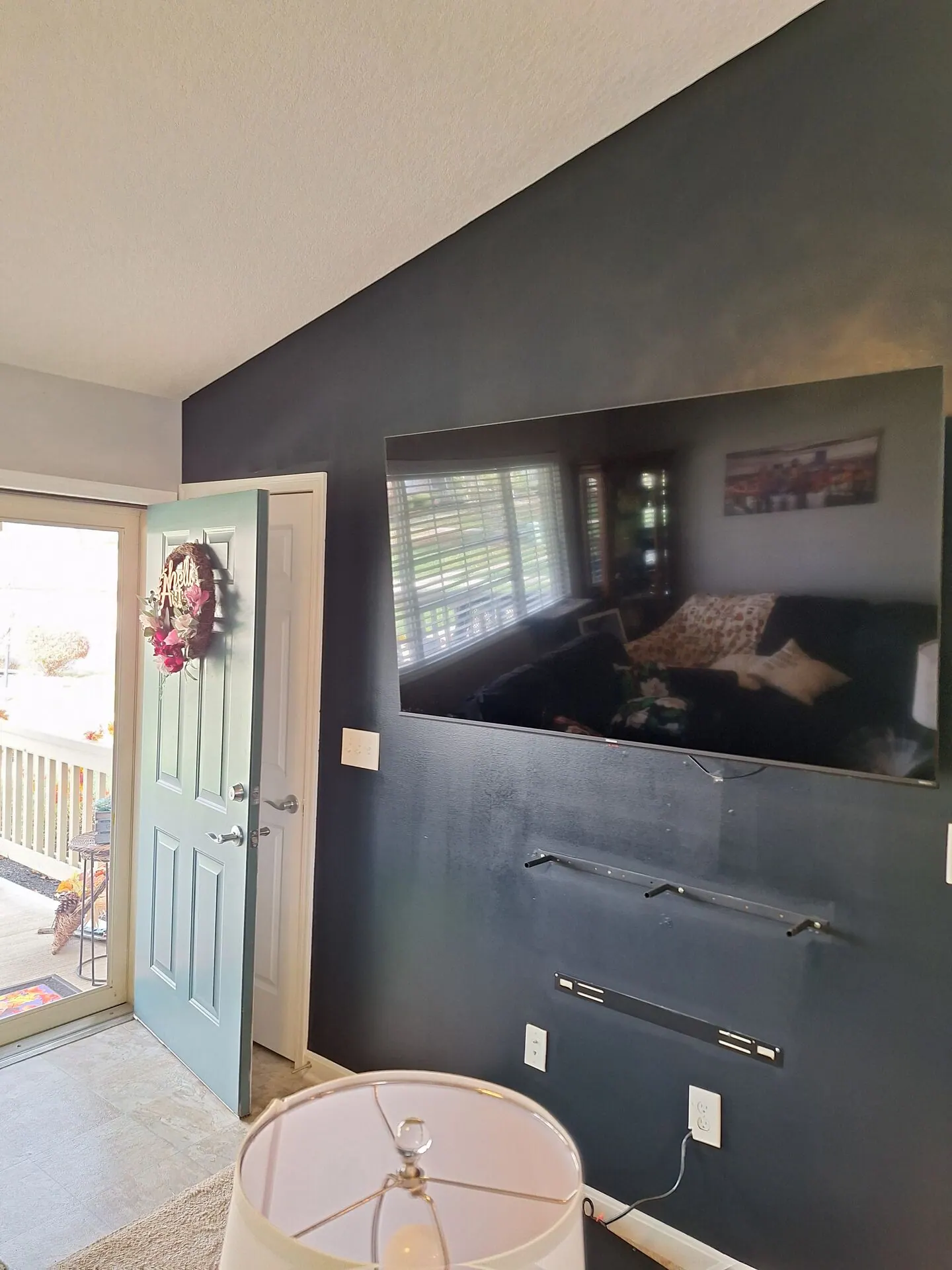 Charcoal accent wall behind a mounted TV