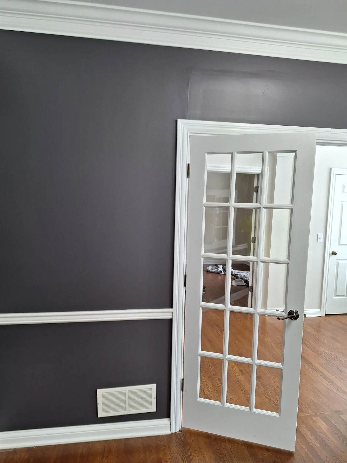 Charcoal gray walls with white chair rail and French door
