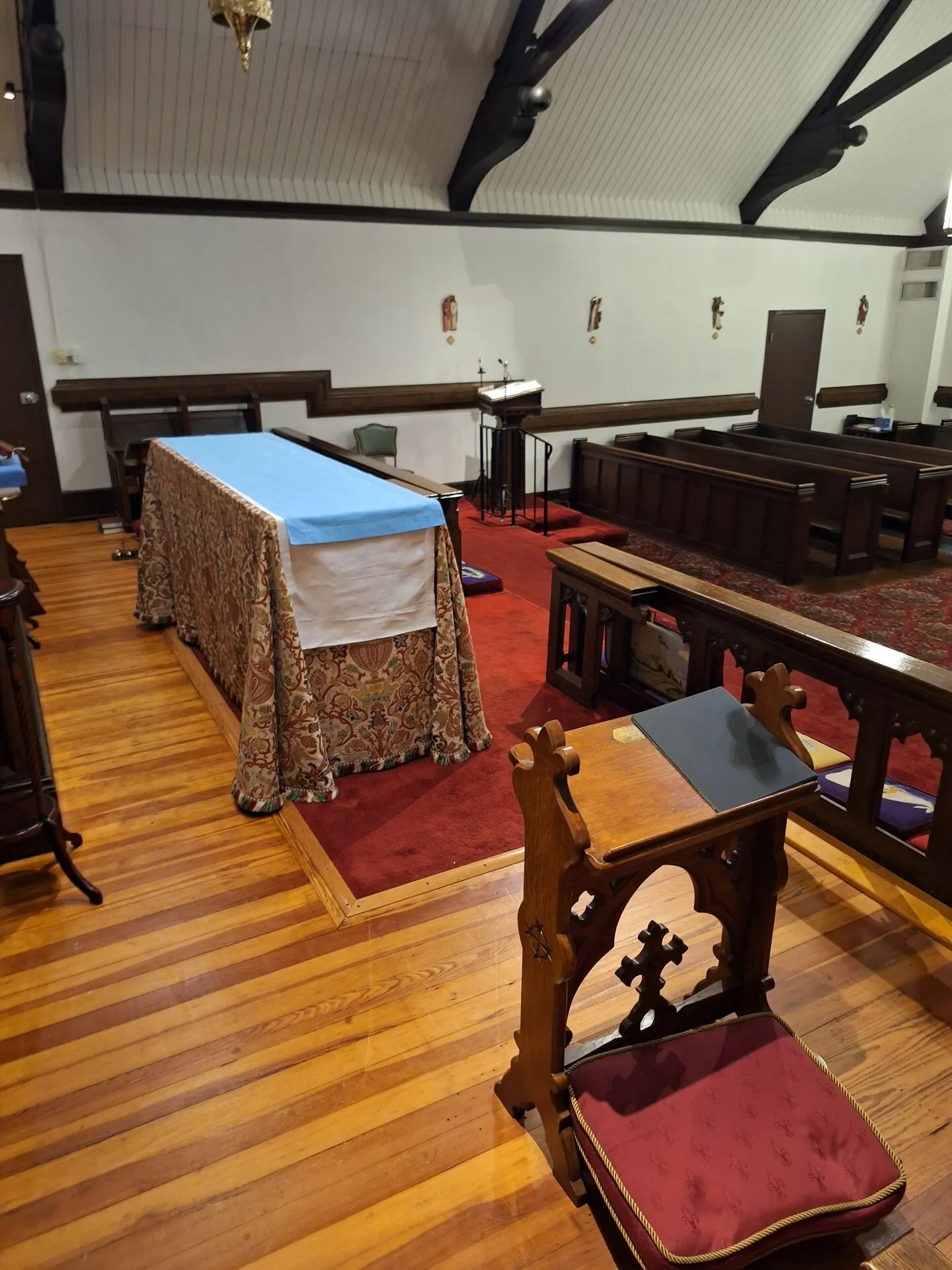 Church sanctuary interior painting with dark timber trusses and white walls