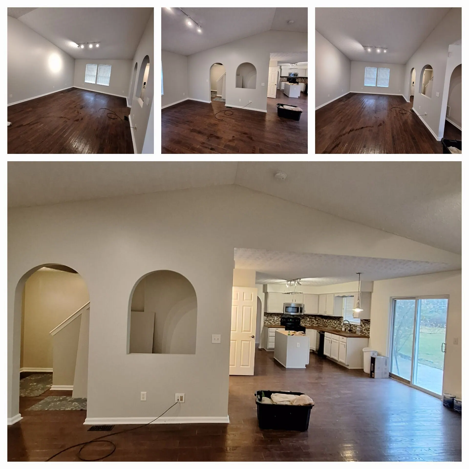 Open-concept great room with arched niches painted light gray