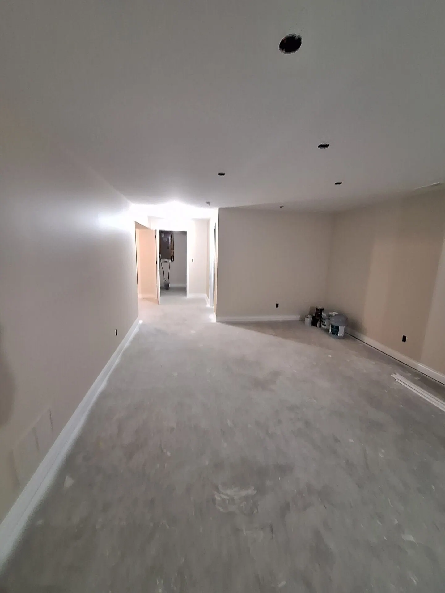 Long basement room freshly painted cream