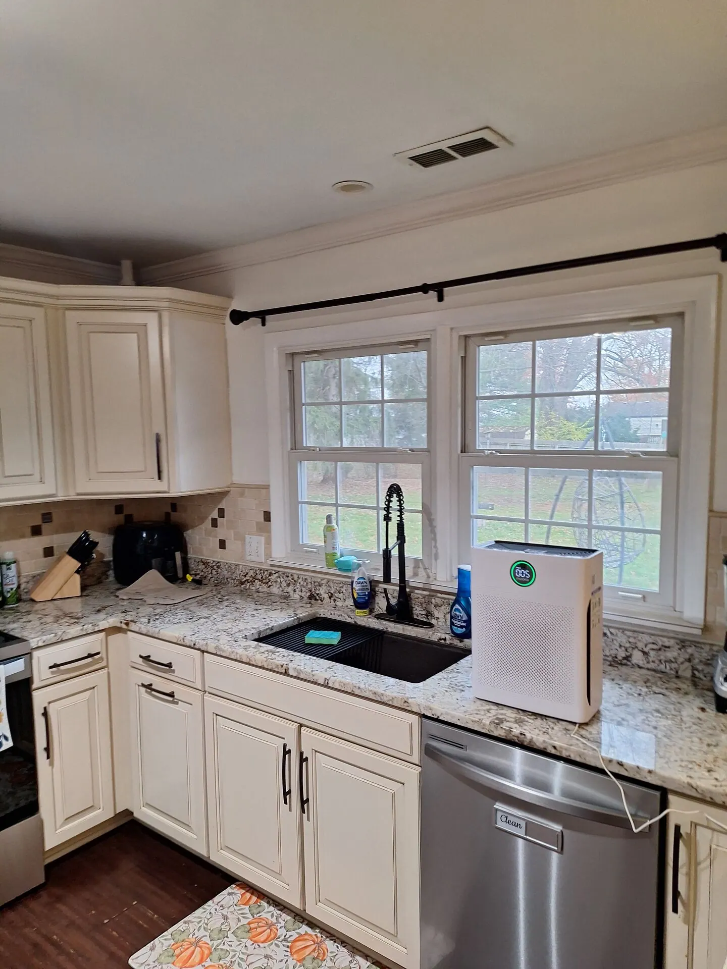 Kitchen with cream cabinets and freshly painted walls