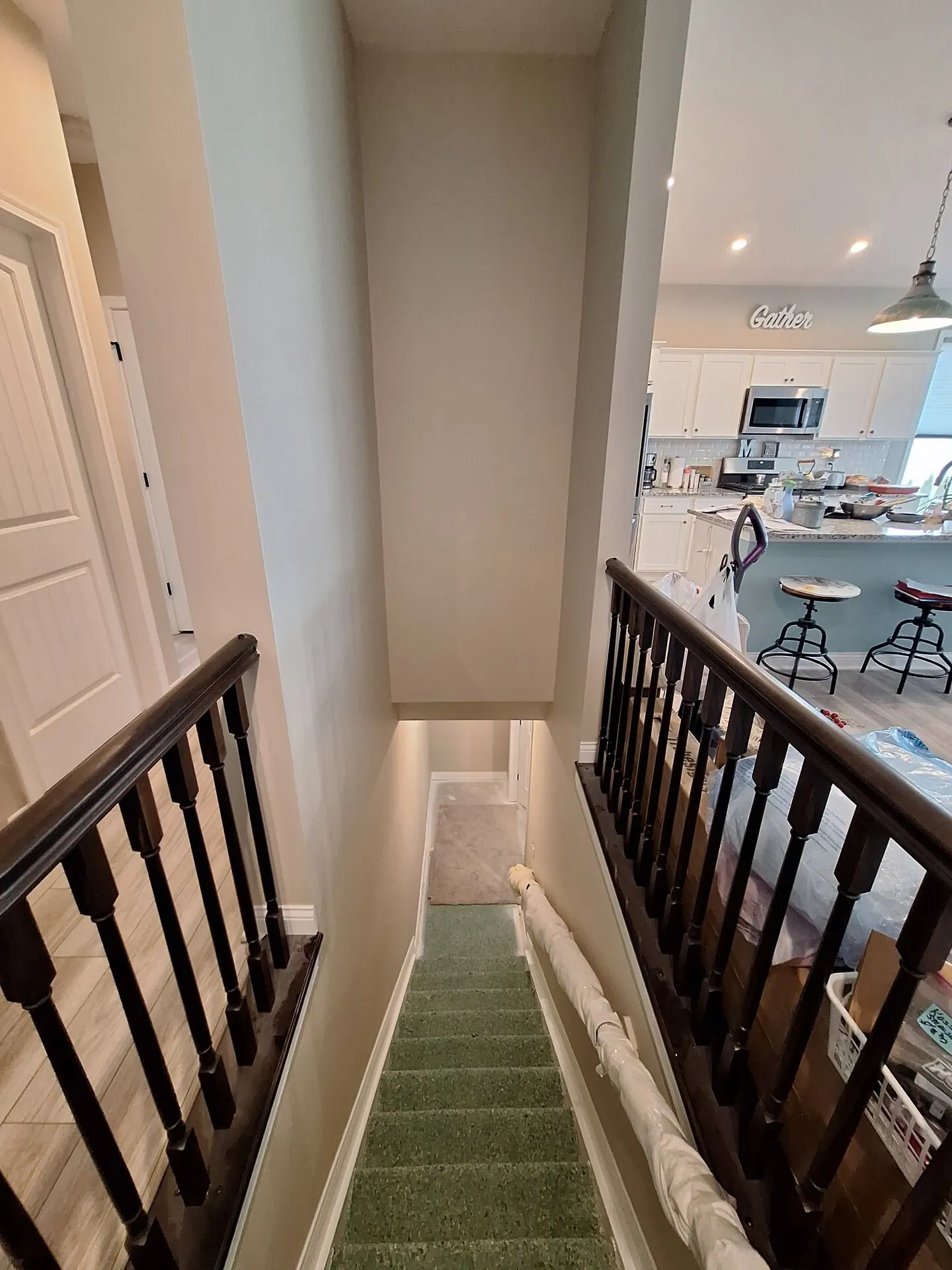 Stairwell painted warm cream with dark railing
