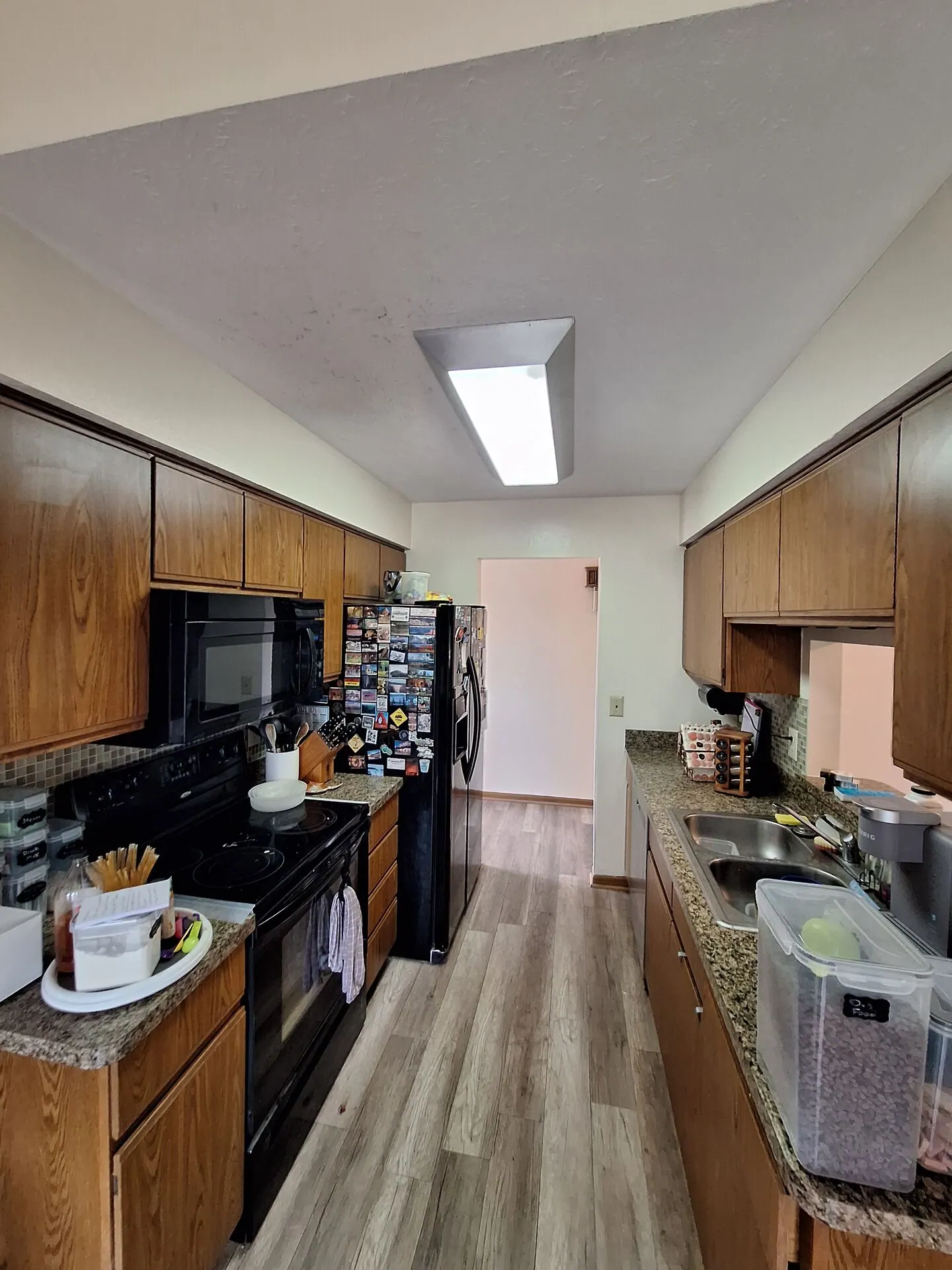 Galley kitchen with freshly painted walls and ceiling
