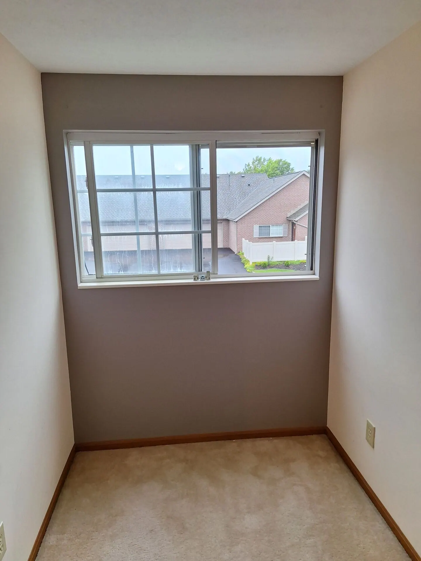 Small room repainted warm gray with white ceiling