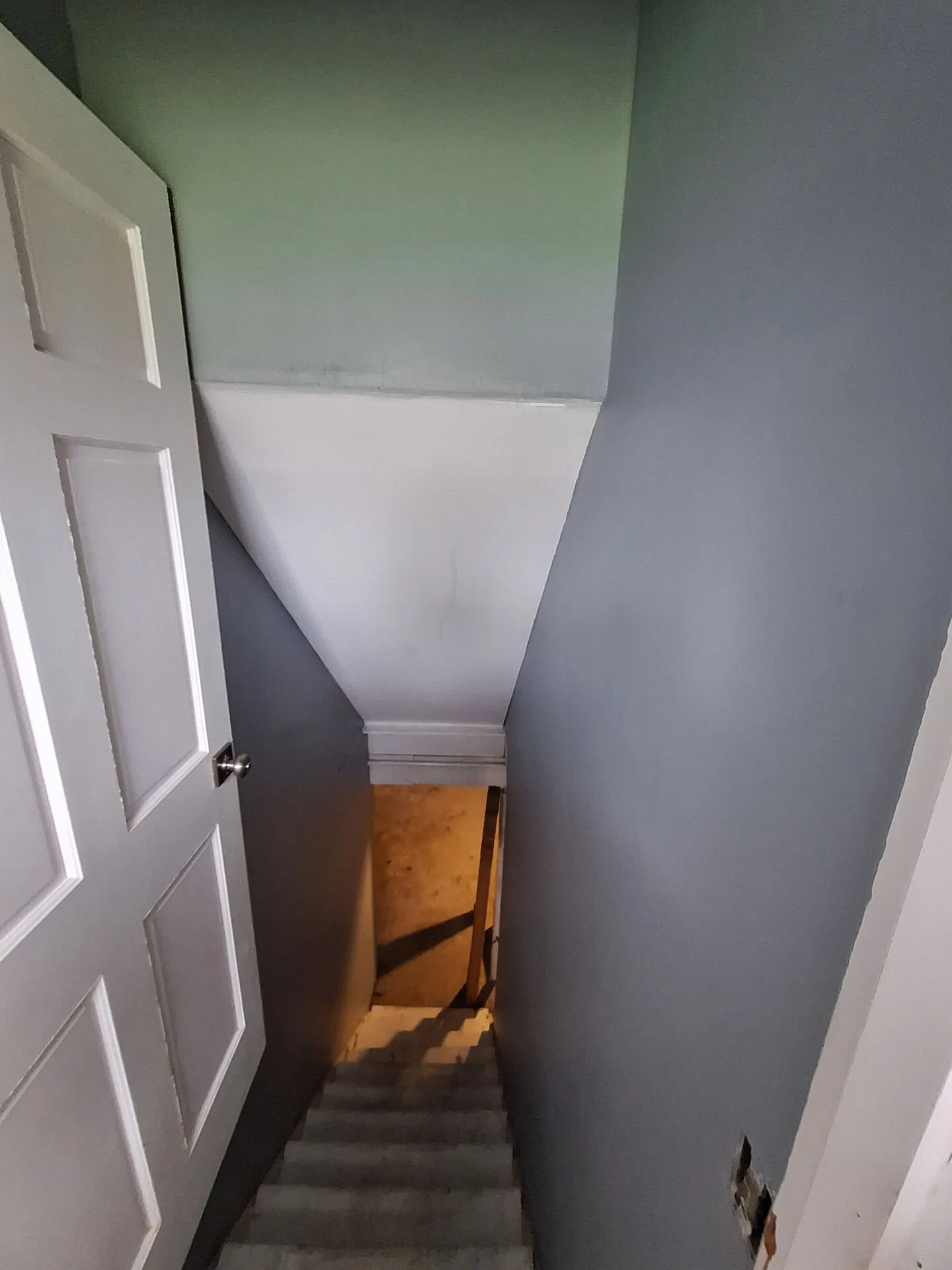 Stairwell with cool gray and green walls