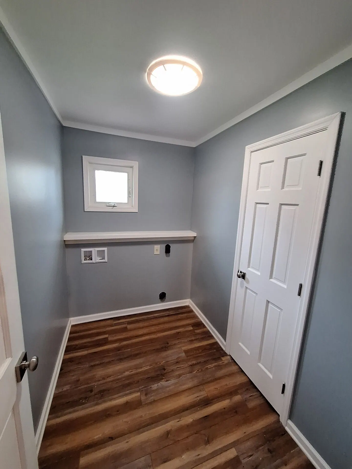 Laundry room painted cool gray with white door