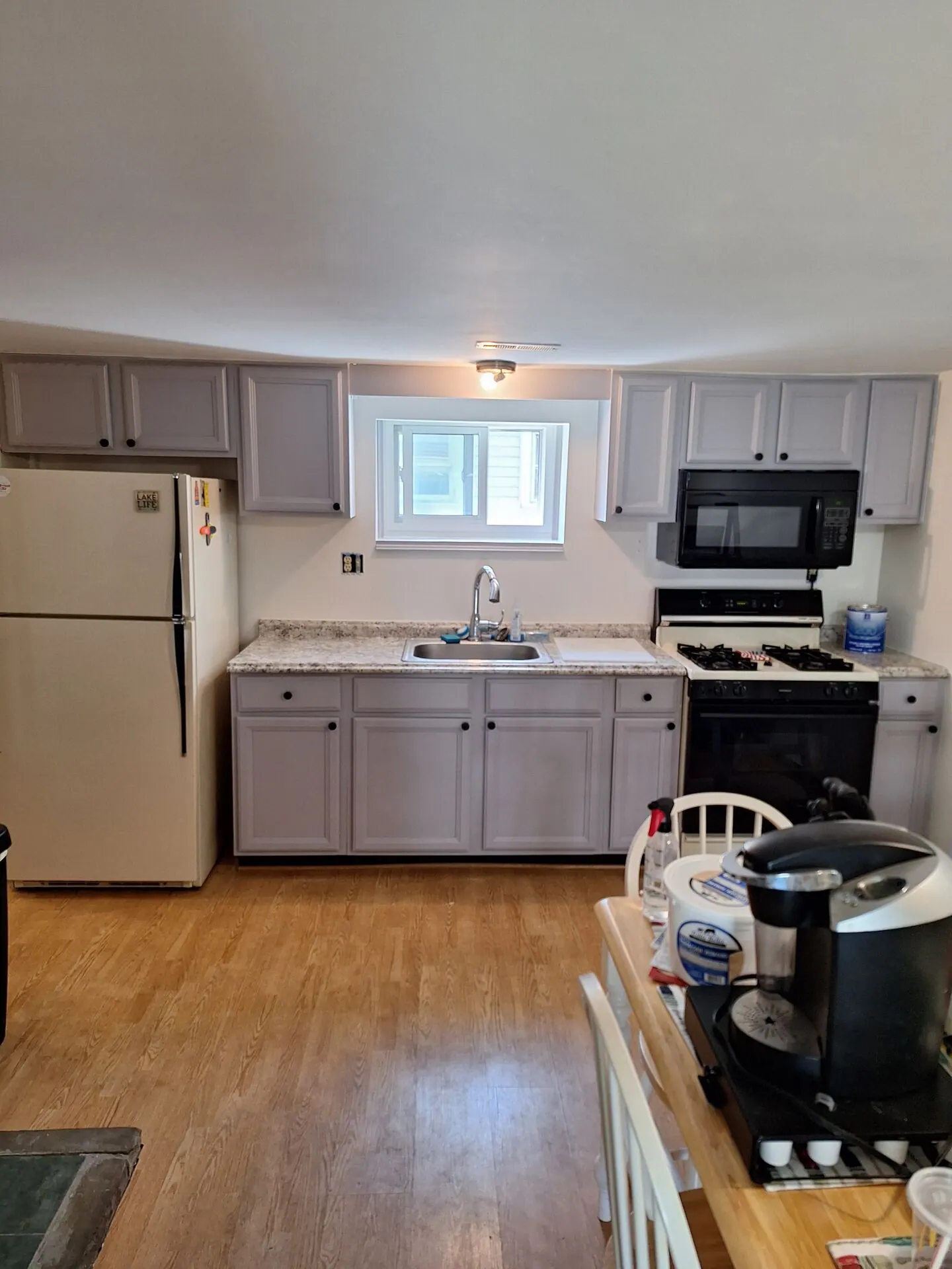 Kitchen with cabinets painted soft gray