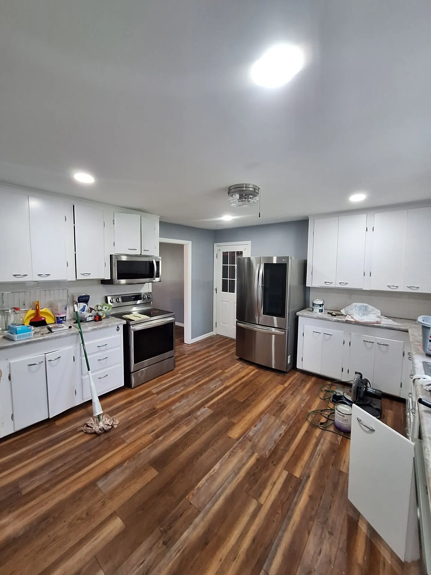 Kitchen with white cabinets and cool gray walls