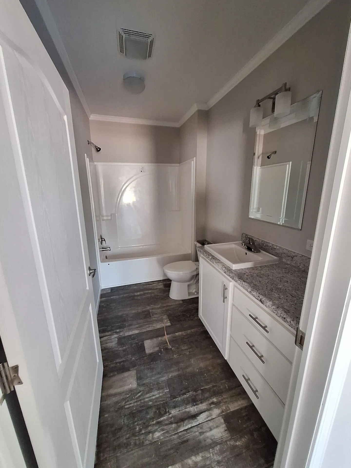 Bathroom repainted warm greige with white vanity