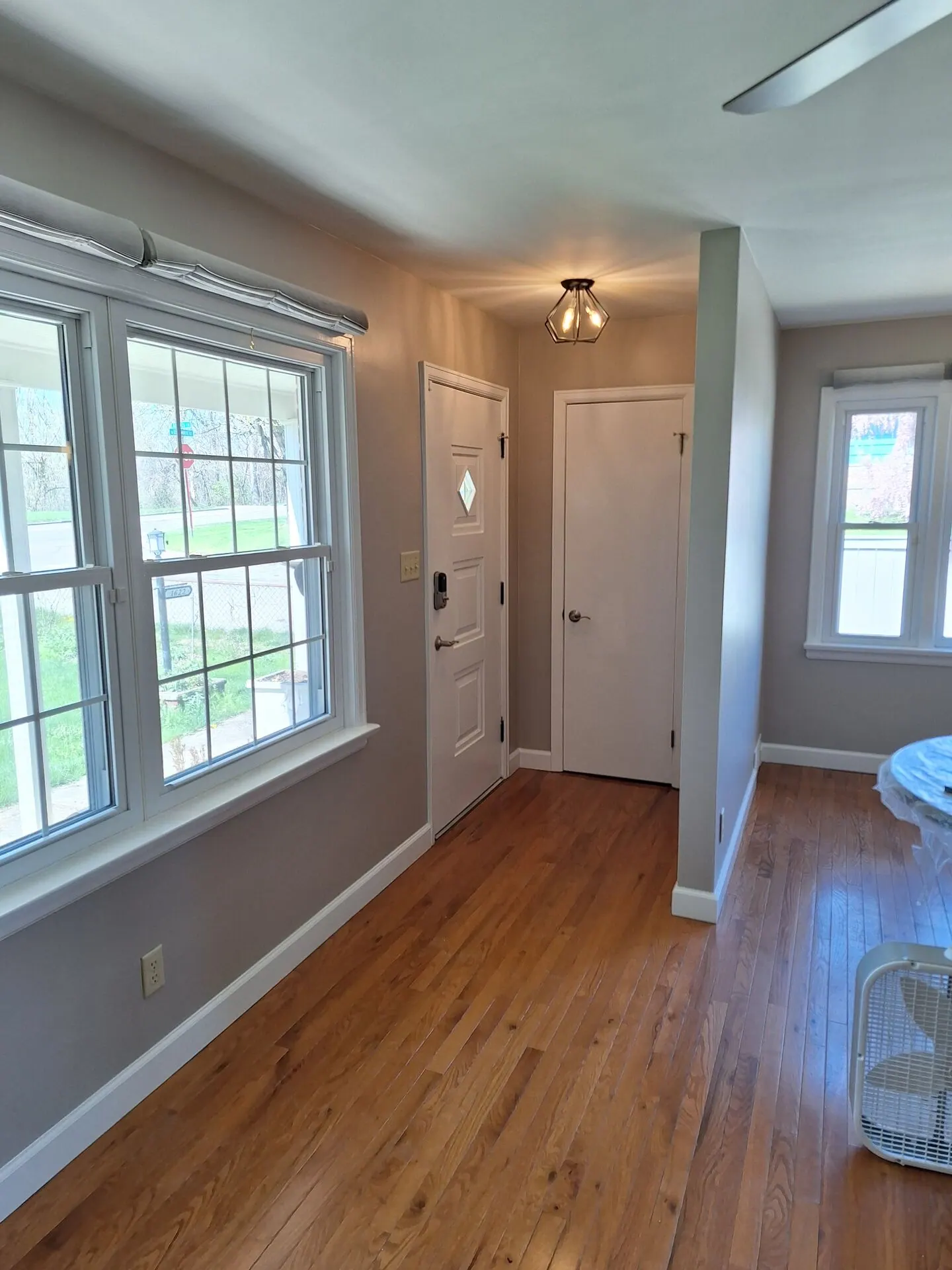 Entry and living room repainted soft greige with white trim