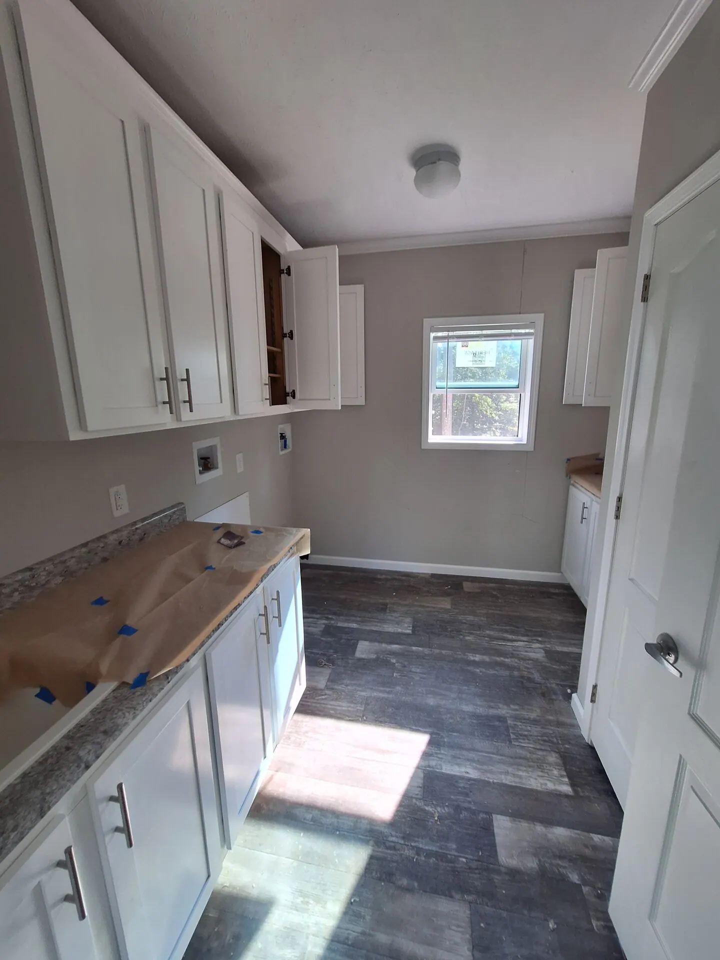 Laundry room with white cabinets and fresh greige walls