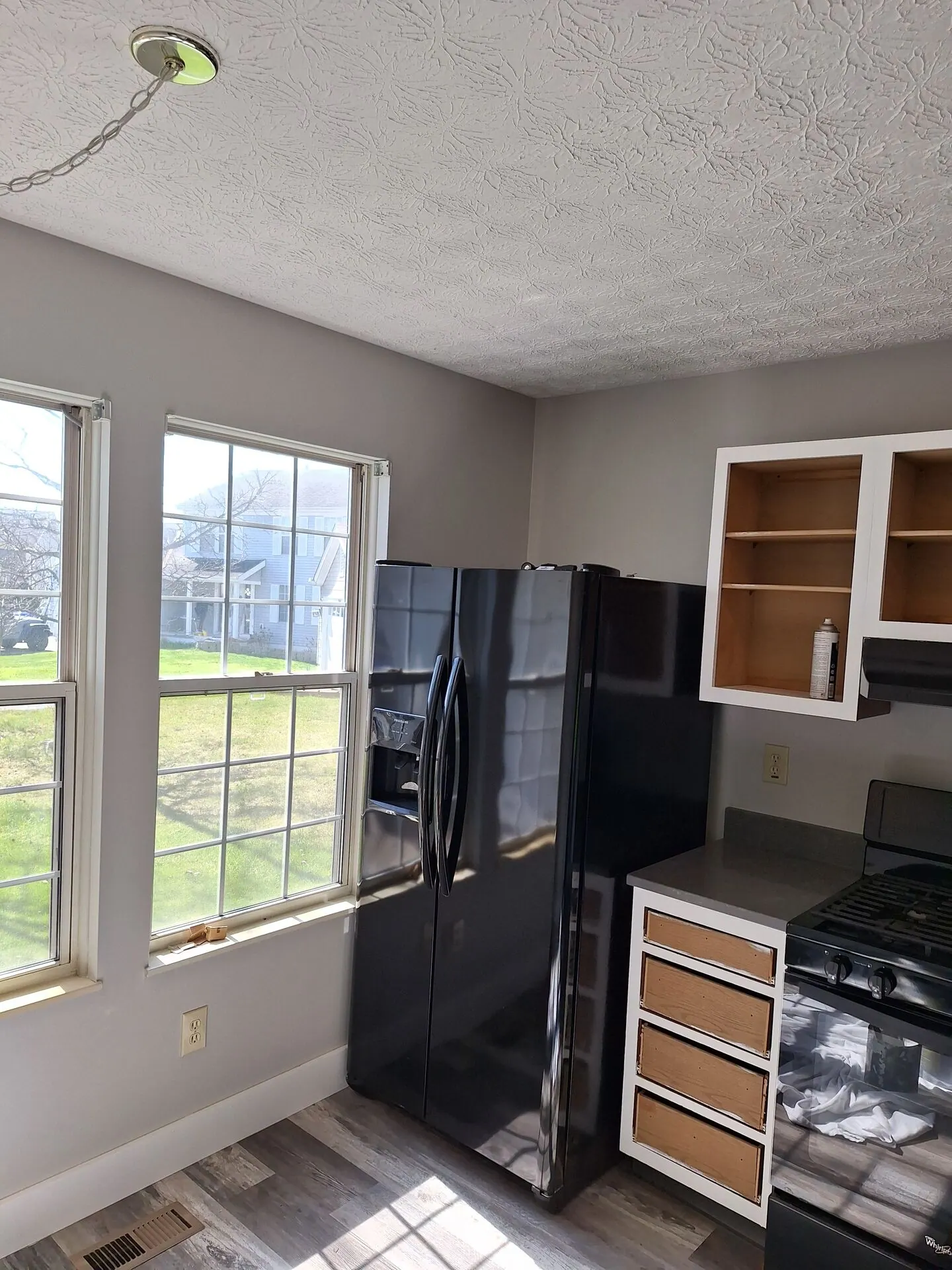 Kitchen repainted soft gray with white cabinet frames