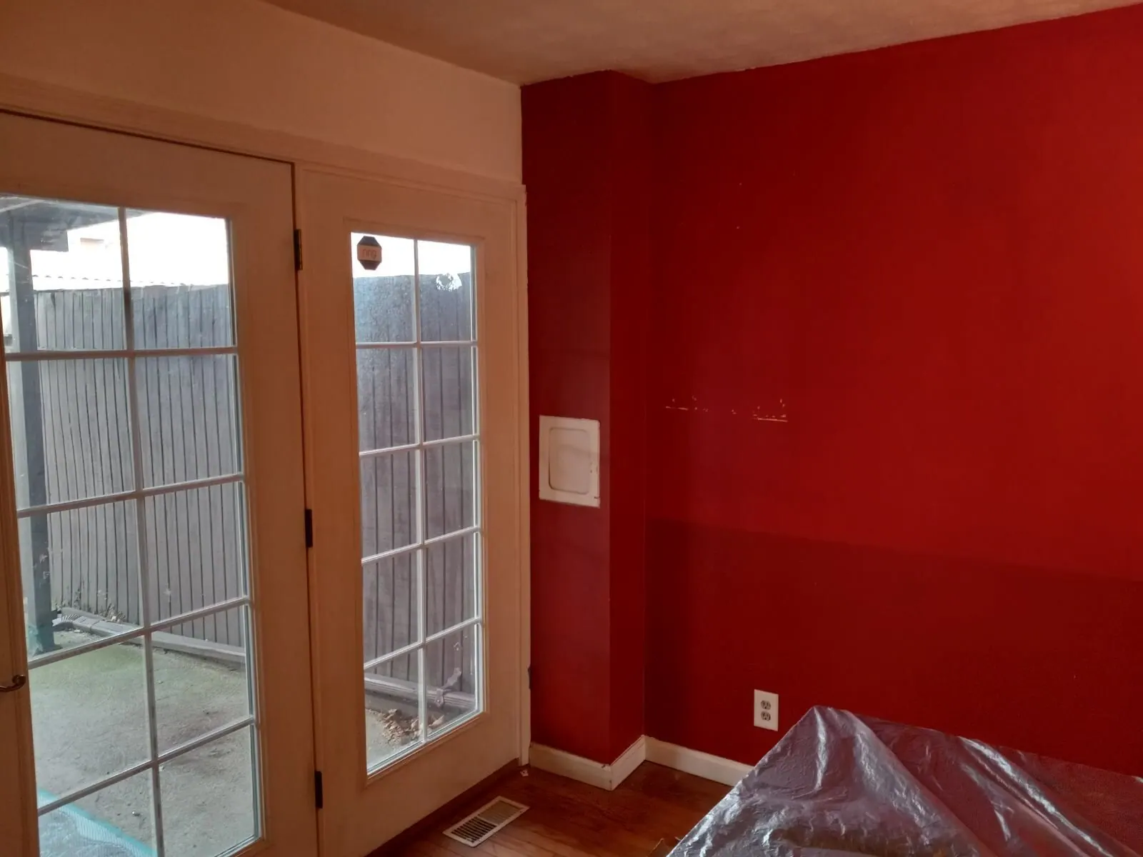 Bold red accent wall beside patio doors