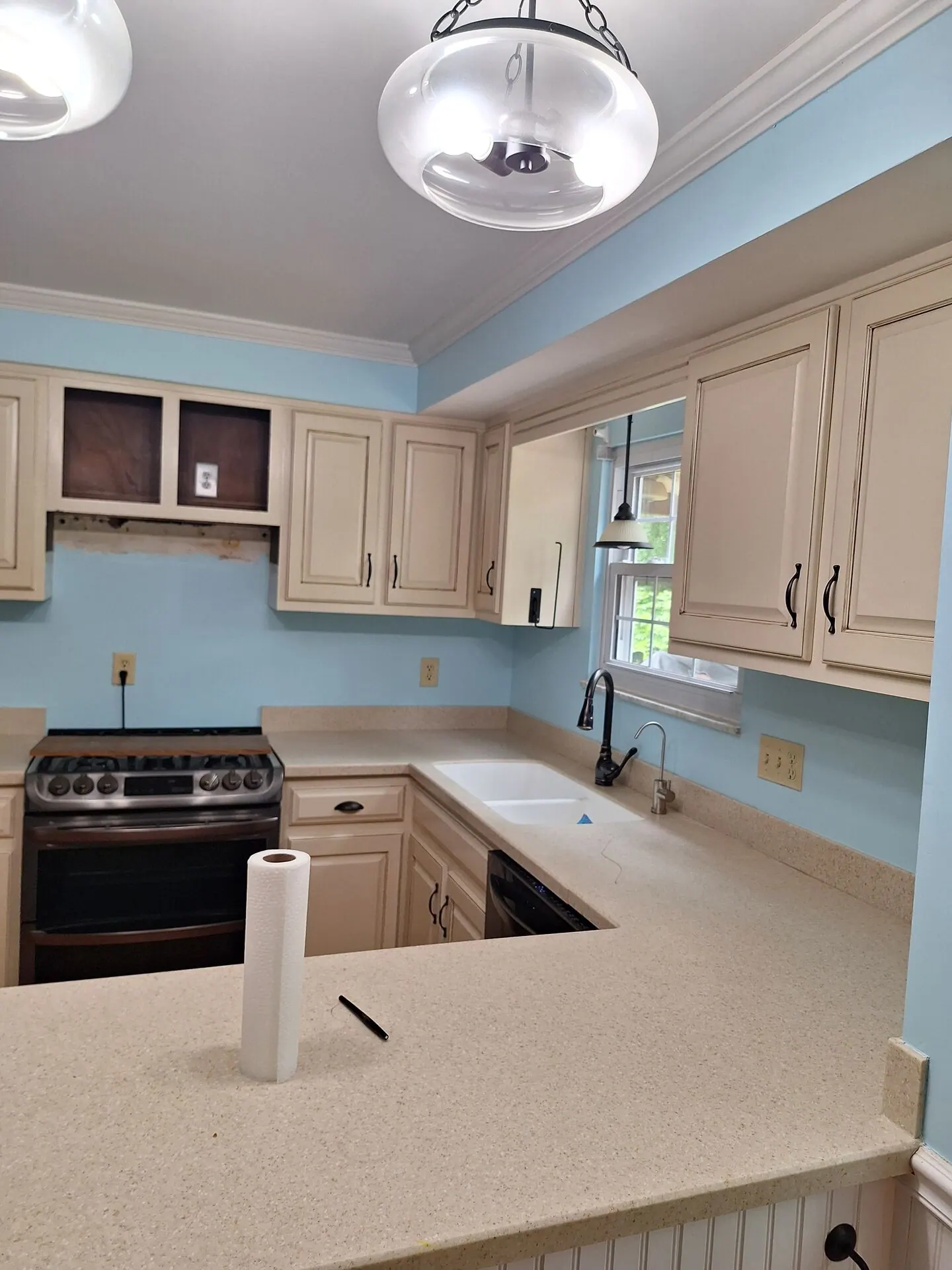 Kitchen with sky blue walls and cream cabinets