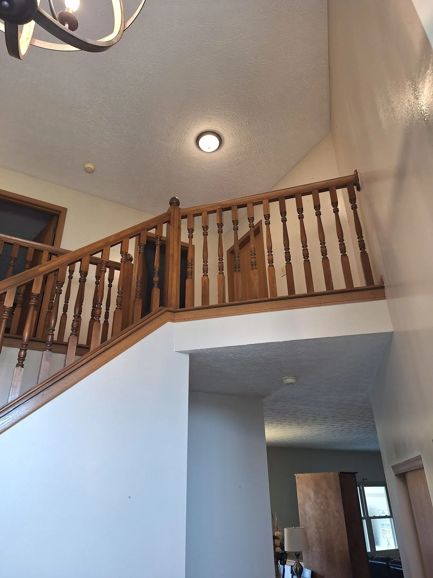 Staircase and landing with freshly painted walls and oak railing