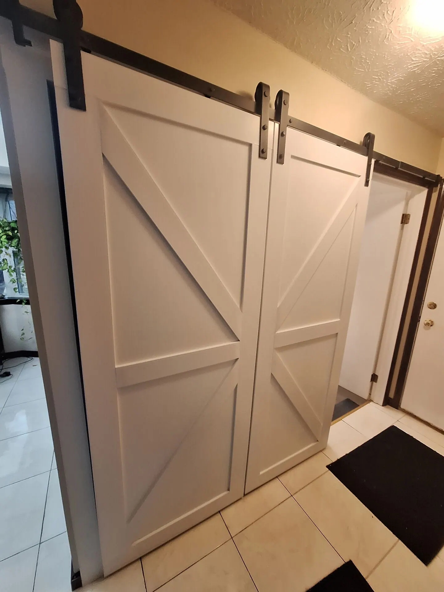 Sliding barn doors painted white with black hardware