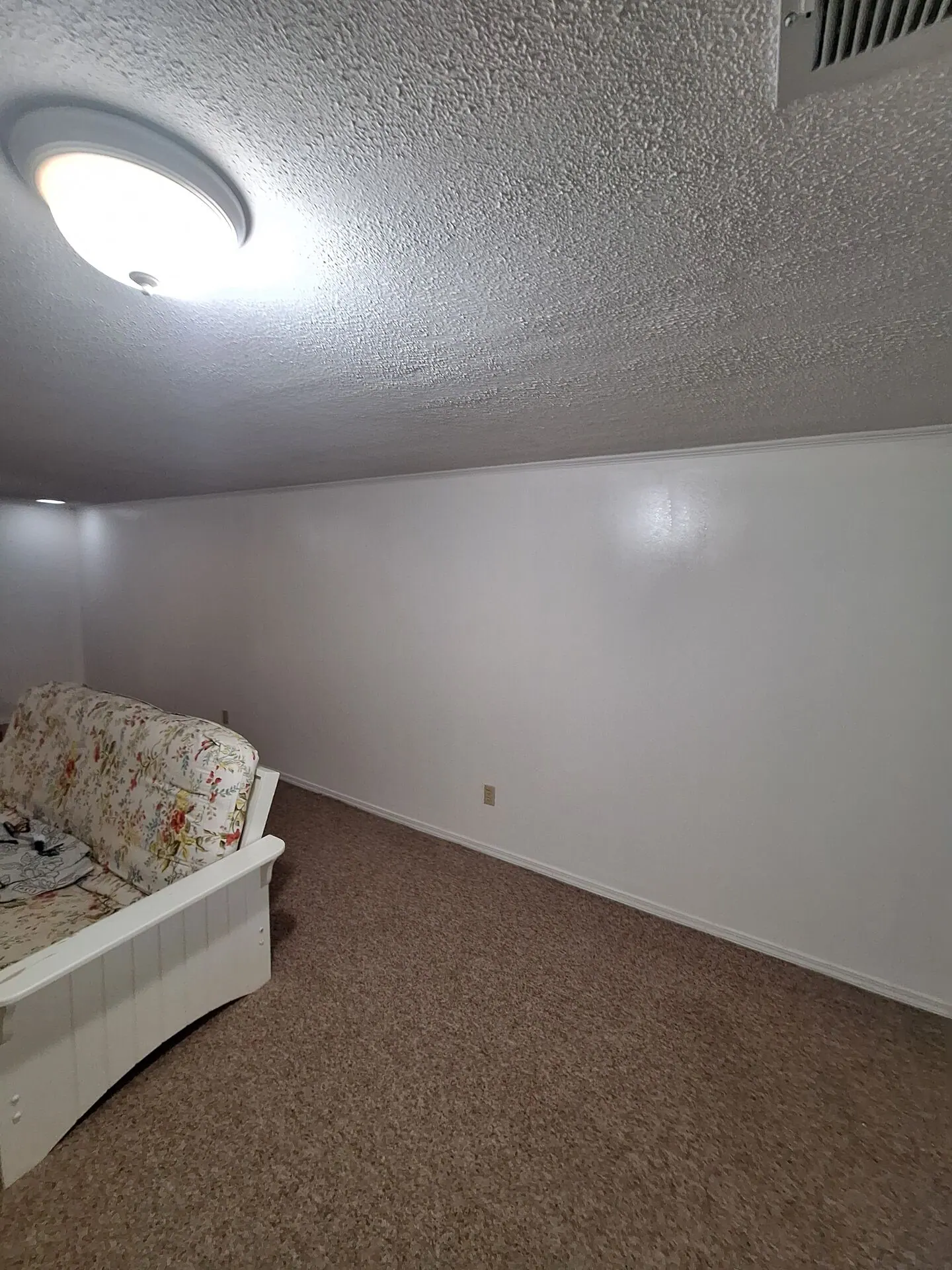 Lower-level bedroom walls painted crisp white