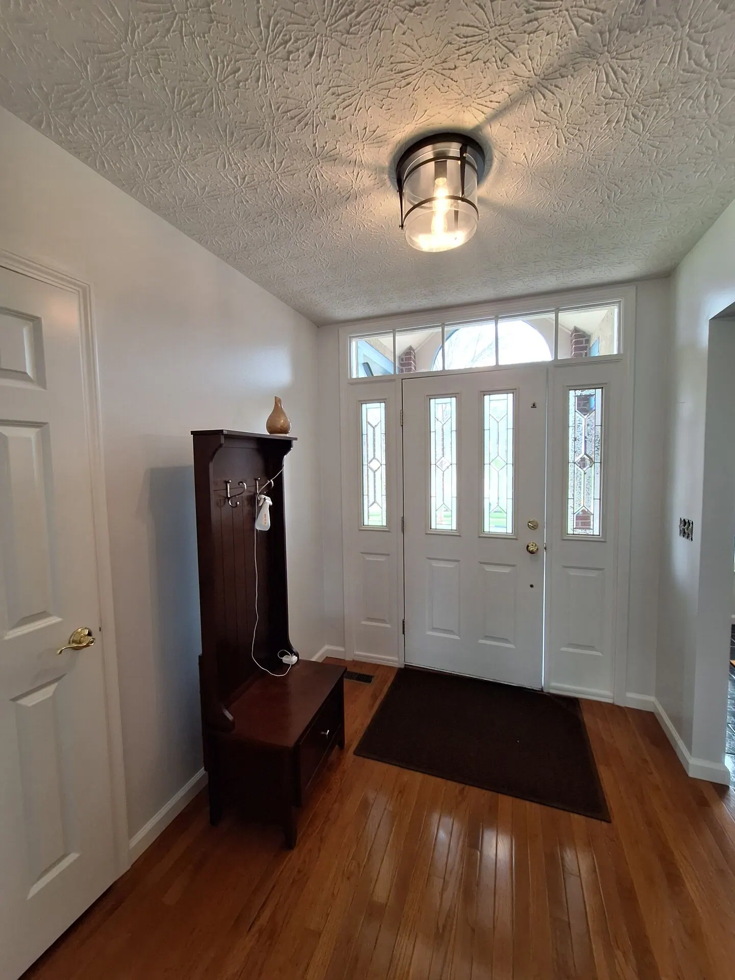 Front entry painted crisp white with sidelights