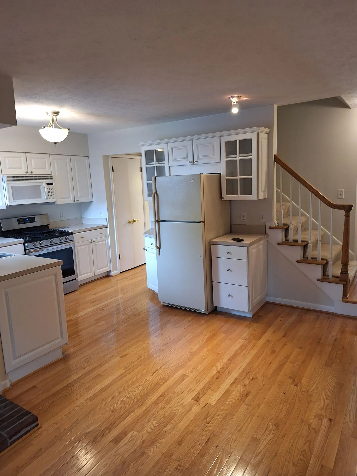 Kitchen and staircase with fresh white walls and ceiling
