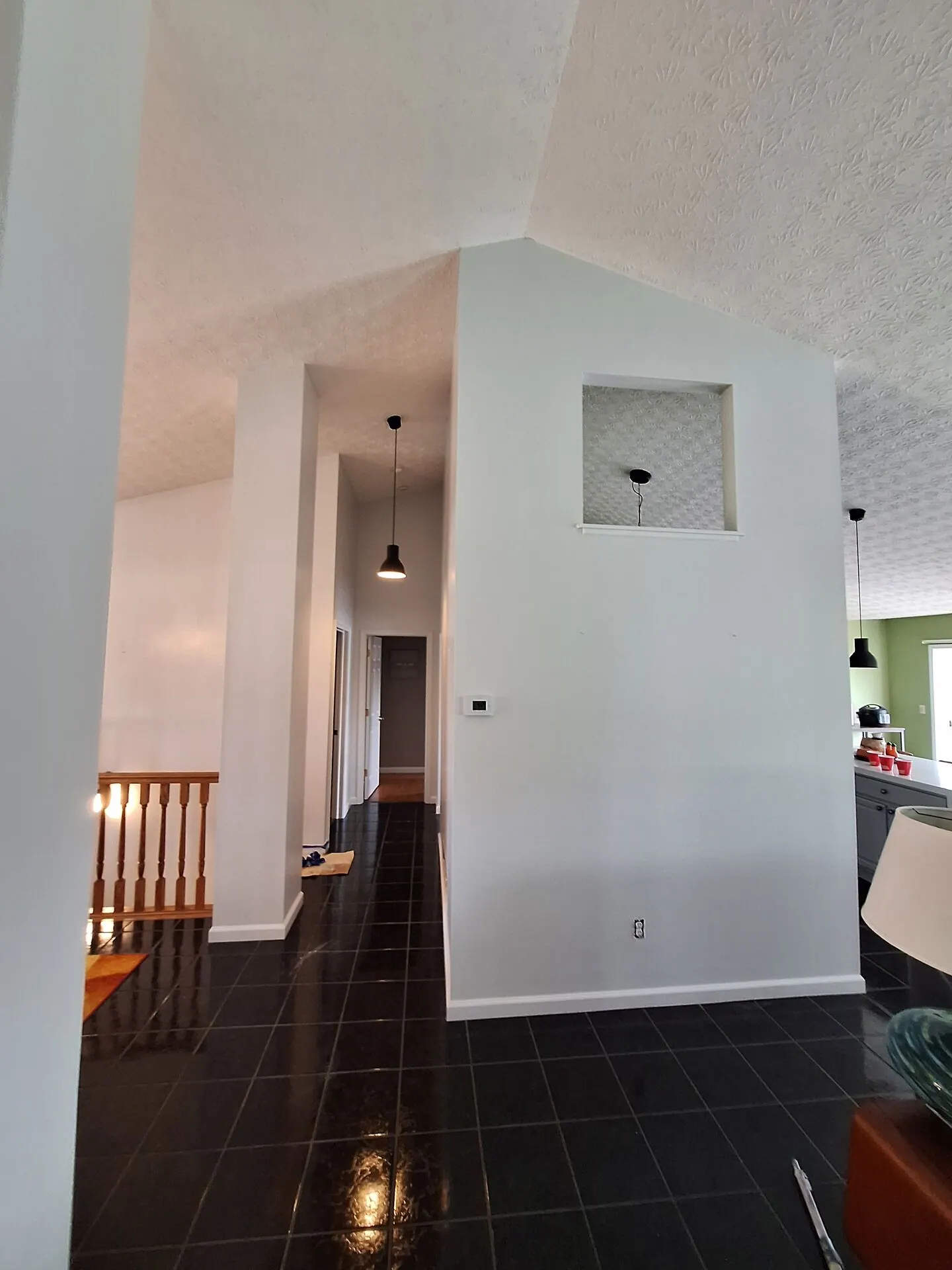Open living space with crisp white walls and vaulted ceiling