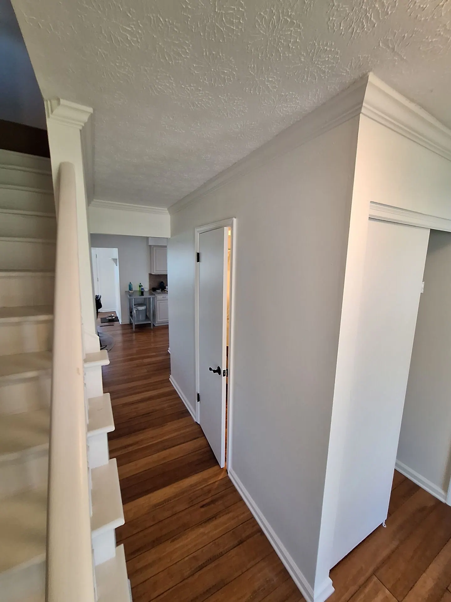Staircase and hallway with fresh white walls and trim