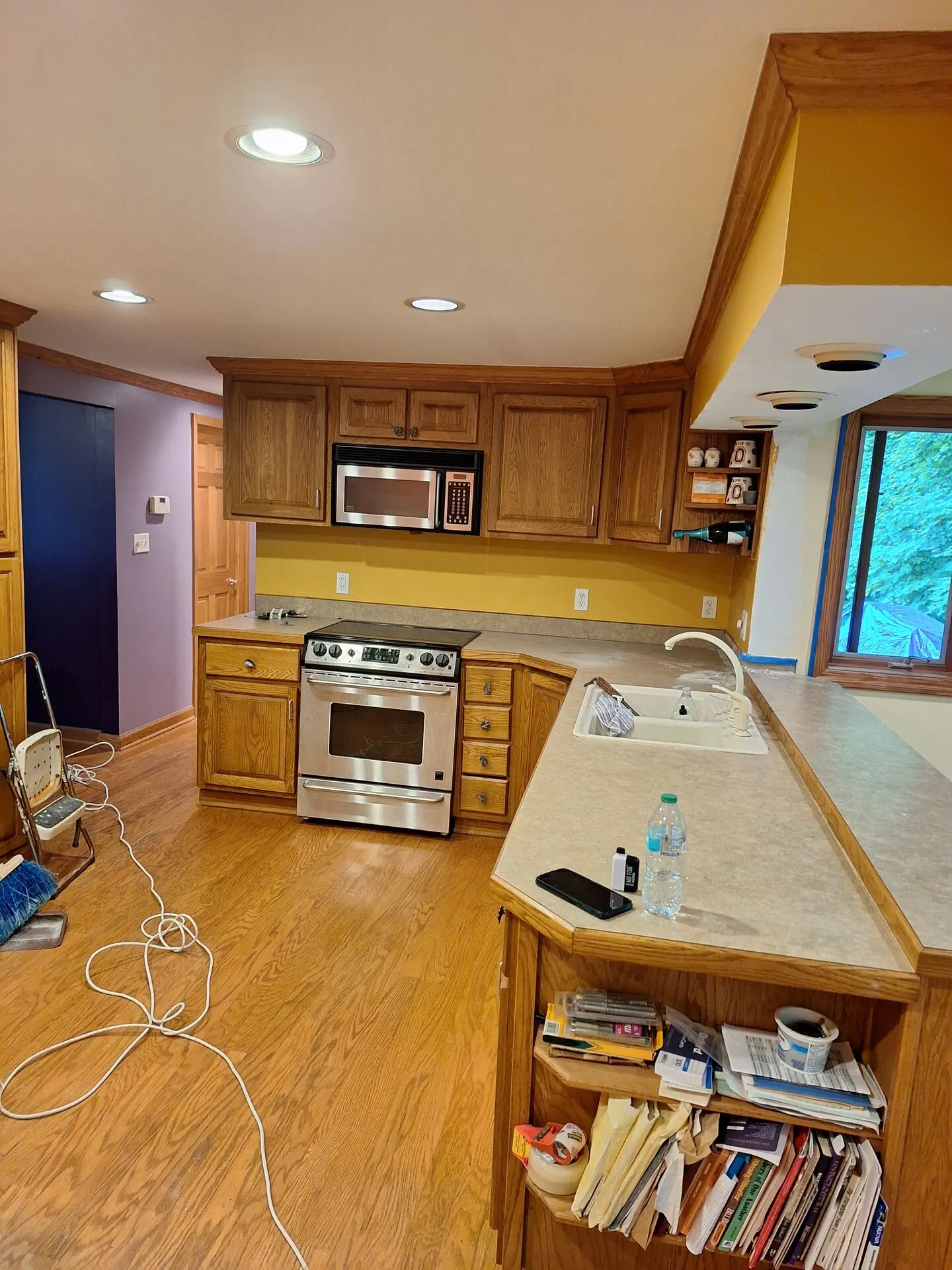 Kitchen with golden yellow walls and oak cabinets